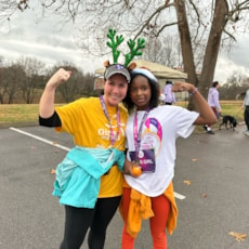 Girls on the Run participant and her running buddy celebrate with their medals